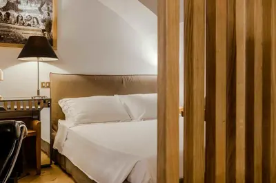 a bedroom with a bed and a desk with a lamp at Piazza Navona Luxury Loft in Rome