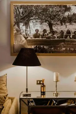 a table with a lamp and a picture on the wall at Piazza Navona Luxury Loft in Rome