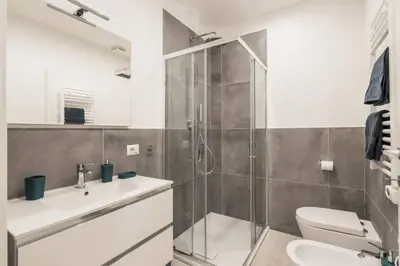 a bathroom with a shower and a toilet and a sink at La Casina 348 in Rome