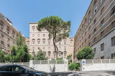 a car parked in front of a large building at La Casina 348 in Rome