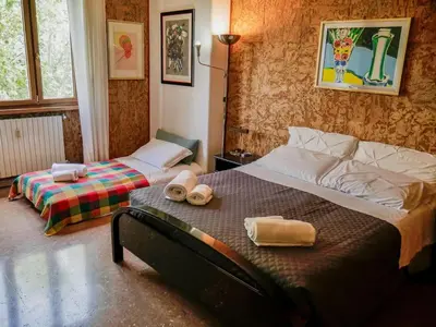 a bedroom with two beds with towels on the bed at Chic and Spacious Rome Penthouse in Rome