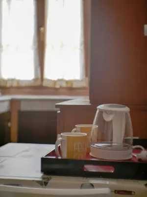 a counter top with a coffee pot and cups on it at Chic and Spacious Rome Penthouse in Rome