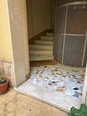 a room with a staircase with a mosaic floor at Chic and Spacious Rome Penthouse in Rome