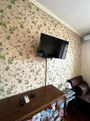 a living room with a flat screen tv on the wall at 129 Gallery’s Studio @ Vatican in Rome