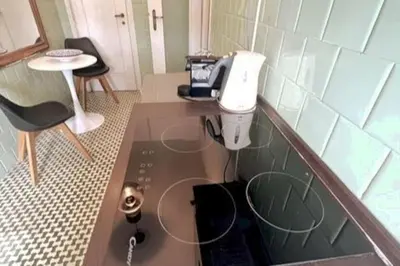 a kitchen with a phone on a counter in a room at 129 Gallery’s Studio @ Vatican in Rome