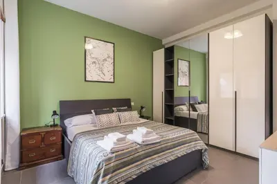 a bedroom with a bed with green walls at One's Place in Rome