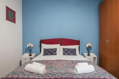 a bedroom with a large bed with two pillows at One's Place in Rome