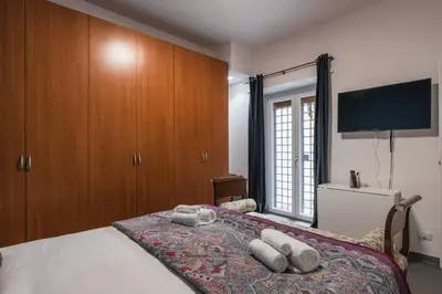 a bedroom with a bed with a flat screen tv at One's Place in Rome