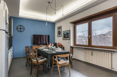 a dining room with a table and chairs at One's Place in Rome