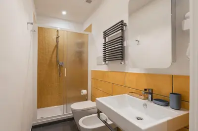 a bathroom with a sink and a toilet and a shower at One's Place in Rome