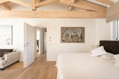 a white bedroom with a zebra painting on the wall at Rome Design Villa in Rome
