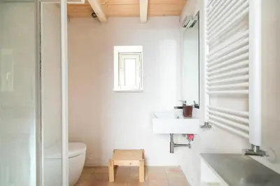 a white bathroom with a sink and a toilet at Rome Design Villa in Rome