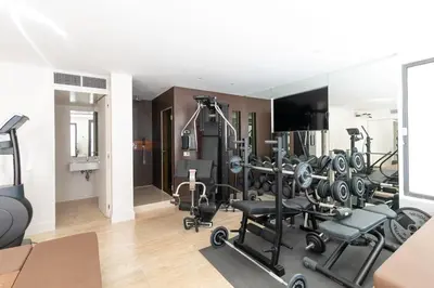 a gym with several treadmills and machines in a room at Rome Design Villa in Rome