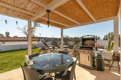 a patio with a table and chairs and a grill at Rome Design Villa in Rome