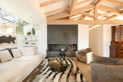 a living room with a white couch and a glass table at Rome Design Villa in Rome