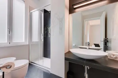 a bathroom with a white sink and a mirror at Beautiful Vatican in Rome