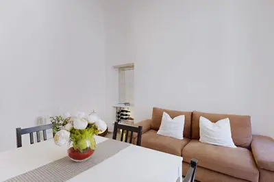a living room with a table and a couch at Casa Vacanze BorgoVI House in Rome