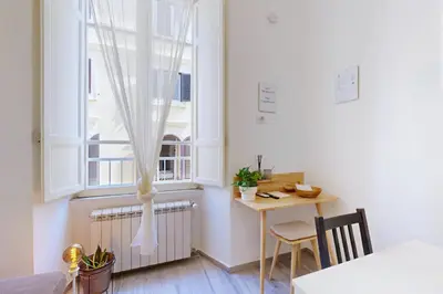 a small kitchen with a table and a window at Casa Vacanze BorgoVI House in Rome