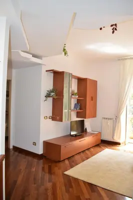 a living room with a tv and a wooden floor at Casa Vacanze Mazzini in Rome