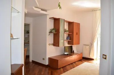 a living room with a tv on a wooden cabinet at Casa Vacanze Mazzini in Rome