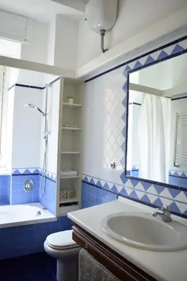 a bathroom with a sink and a toilet and a mirror at Casa Vacanze Mazzini in Rome