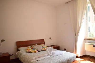 a bedroom with two beds and a window at Casa Vacanze Mazzini in Rome