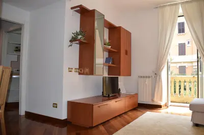 a living room with a tv on a wooden dresser at Casa Vacanze Mazzini in Rome