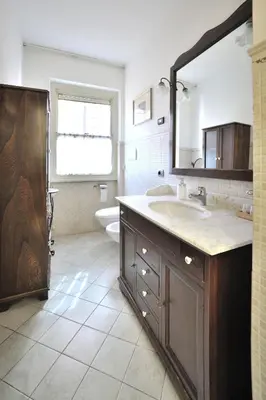 a bathroom with a sink and a toilet and a mirror at FleminHouse a soli 10 min da San Pietro in Rome
