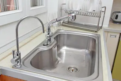 a stainless steel kitchen sink with a faucet at FleminHouse a soli 10 min da San Pietro in Rome