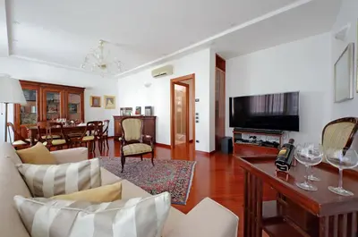 a living room with a couch and a tv and a table at FleminHouse a soli 10 min da San Pietro in Rome