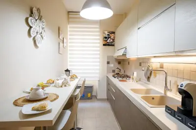 a kitchen with a sink and a counter top at Aureliana House Roma in Rome