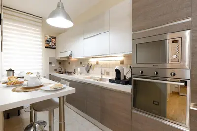 a kitchen with a sink and a stove top oven at Aureliana House Roma in Rome