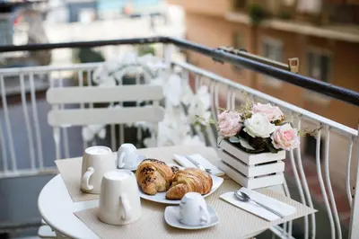 a table with croissants and pastries on a balcony at Aureliana House Roma in Rome