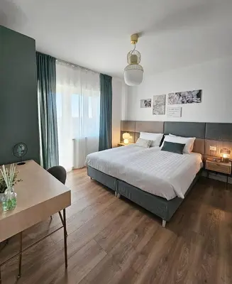 a bedroom with a large bed and a table at B&B Domus Teano Luxury Rooms in Rome
