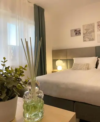 a bedroom with a bed and a vase on a table at B&B Domus Teano Luxury Rooms in Rome