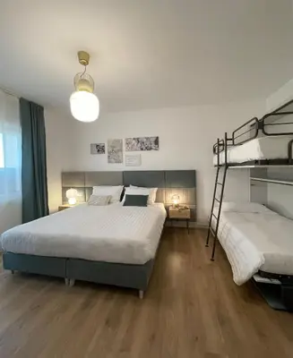 a bedroom with two bunk beds and a lamp at B&B Domus Teano Luxury Rooms in Rome