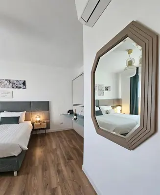 a bedroom with a large mirror on the wall at B&B Domus Teano Luxury Rooms in Rome