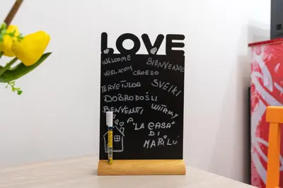 a chalkboard sign with the word love written on it at La Casa di Marilù Vicino a Trastevere in Rome