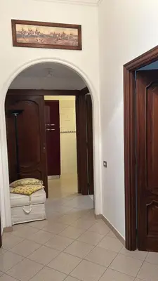 a hallway with an archway in a room with a bathroom at Vatican Vittoria Suite in Rome
