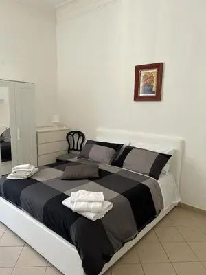 a bedroom with a large bed with two towels on it at Vatican Vittoria Suite in Rome