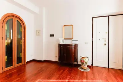 a room with a mirror and a vase on a wooden floor at Delizioso apartment Porta Metronia Roma in Rome