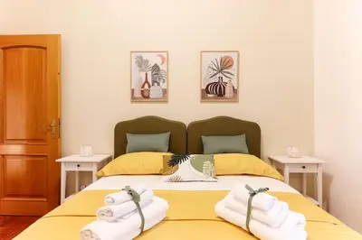 a bedroom with a bed with towels on it at Delizioso apartment Porta Metronia Roma in Rome