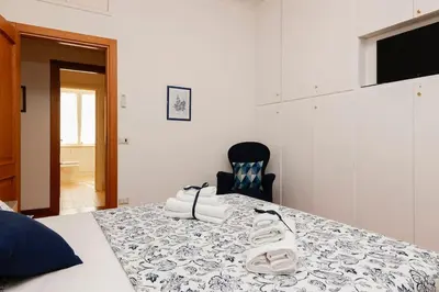 a bedroom with a table with a pair of shoes on it at Delizioso apartment Porta Metronia Roma in Rome