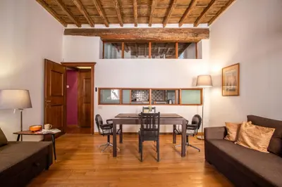a living room with a table and a couch at Trastevering in Rome in Rome