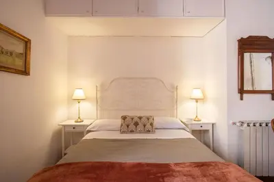 a bedroom with a large bed with two night stands at Trastevering in Rome in Rome
