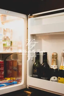 an open refrigerator filled with bottles of beer at Villa della Fonte in Rome