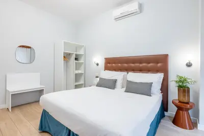 a bedroom with a large bed with white sheets and pillows at Domus Bella Roma in Rome