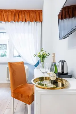 a kitchen with a table with wine glasses and a chair at Domus Bella Roma in Rome