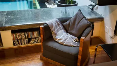 a chair with a pillow on it under a desk at Rental in Rome Riari Garden in Rome