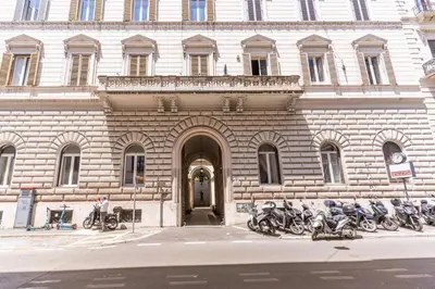 a building with motorcycles parked in front of it at XX SETT: Flat by Barberini Trevi Fountain in Rome